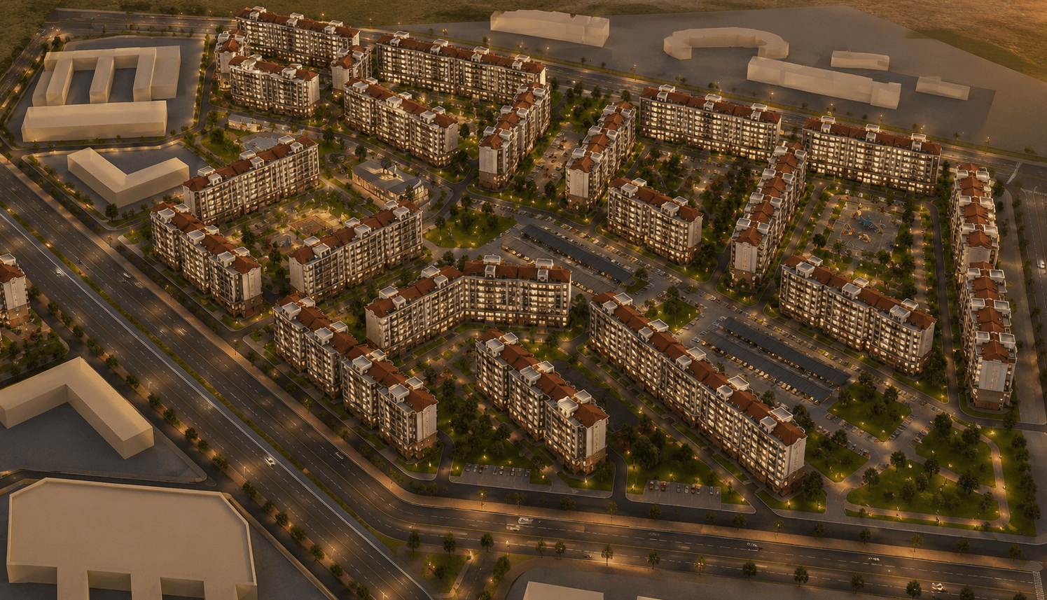 Aerial view of a large, illuminated residential complex with red-roofed buildings and landscaped courtyards.